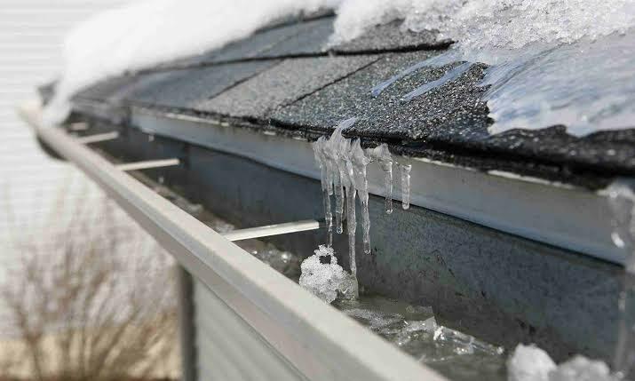 Ice dams and icicles along a roof edge