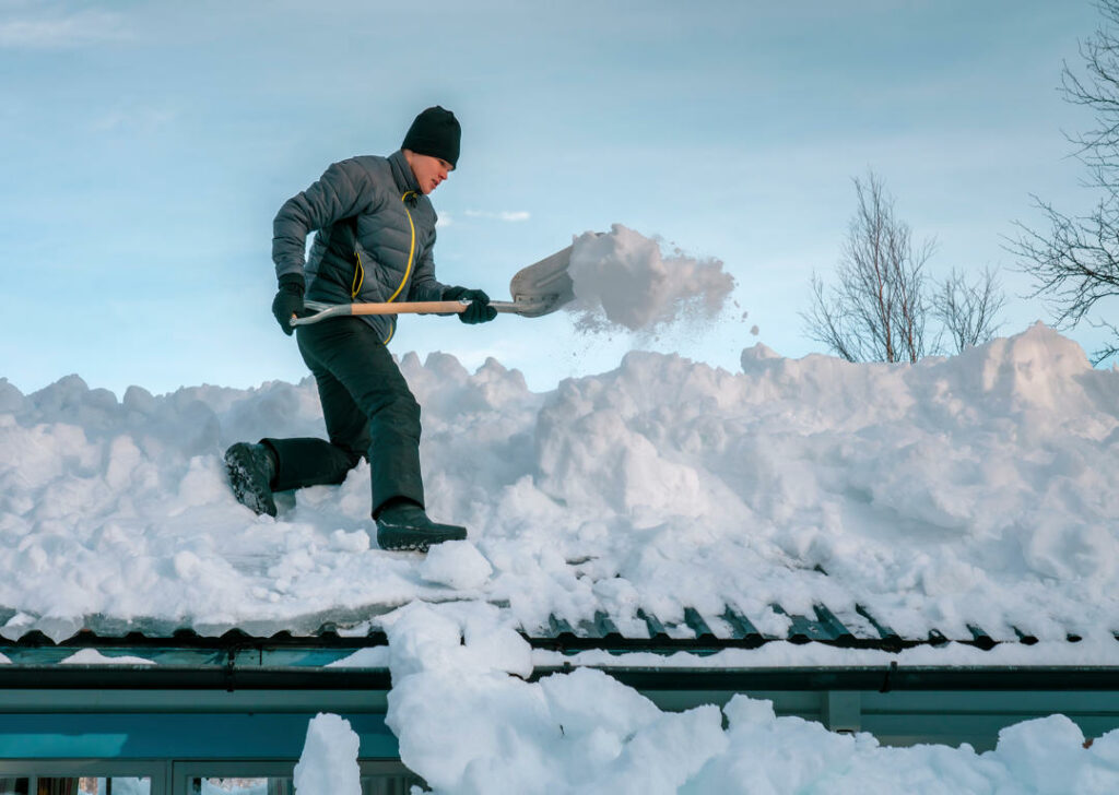 Shoveling heavy snow accumulation off a roof Shoveling heavy snow accumulation off a roof