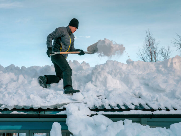 Shoveling heavy snow accumulation off a roof Shoveling heavy snow accumulation off a roof
