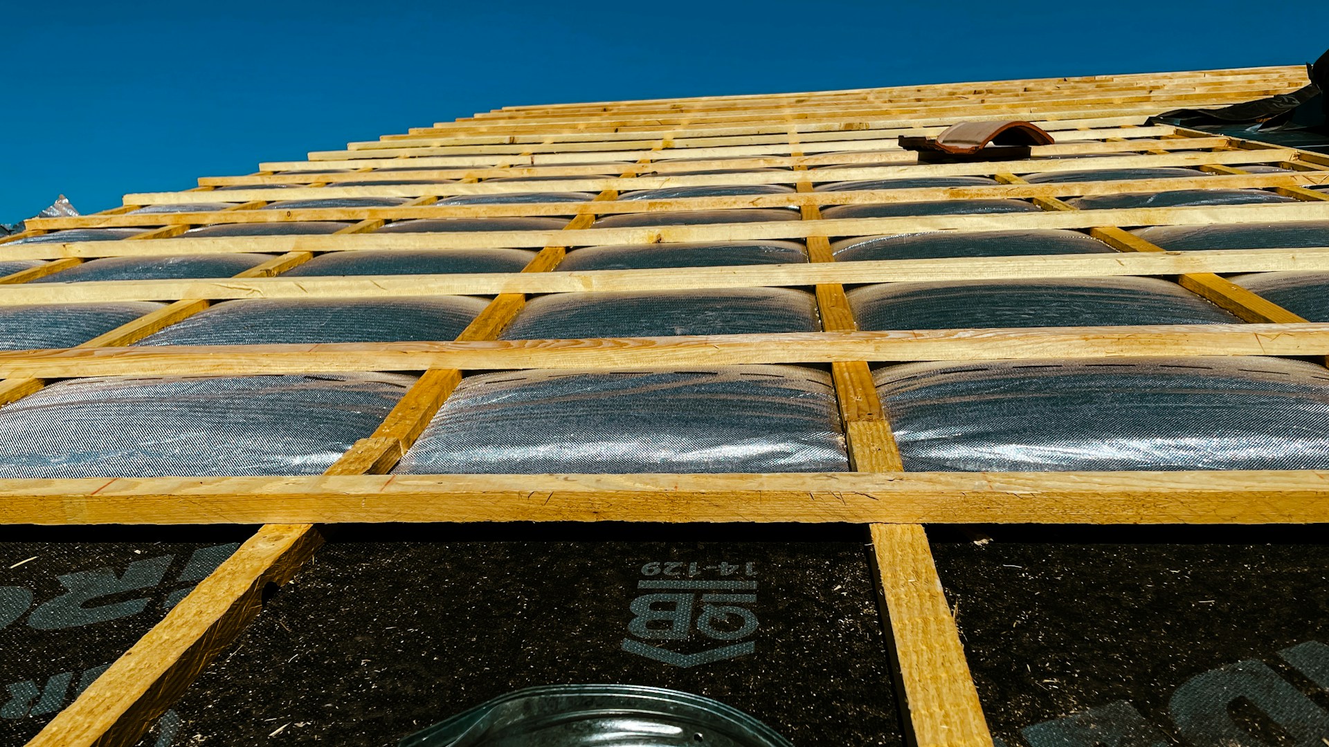 Wooden battens fastened over underlayment on a roof under construction