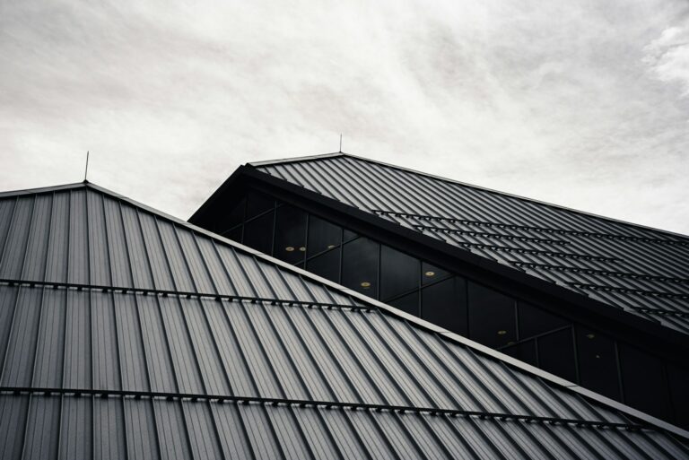 Dark standing seam metal roofs against a cloudy sky Dark standing seam metal roofs against a cloudy sky